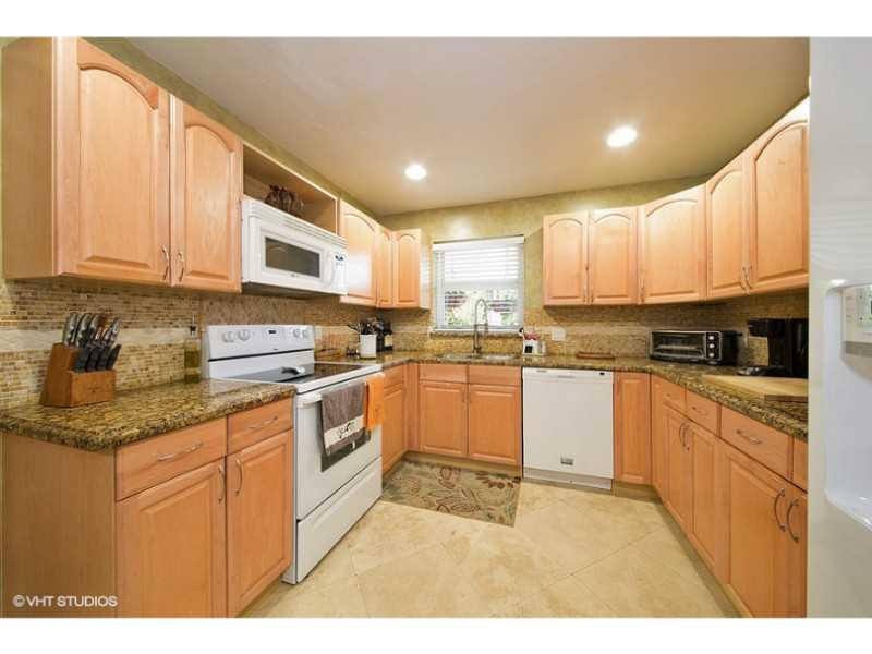 10139 Windtree Lane Boca Raton, FL 33428 - Photo 11 of 15 a kitchen with stainless steel appliances granite countertop a stove a sink and a microwave