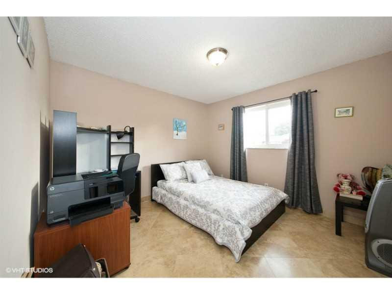 10139 Windtree Lane Boca Raton, FL 33428 - Photo 4 of 15 a bedroom with a bed and wooden floor
