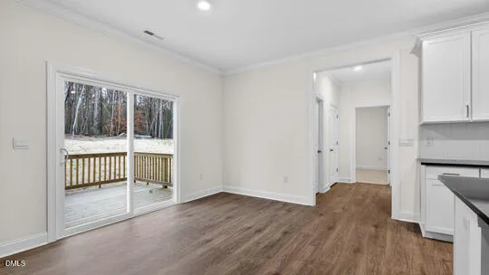an empty room with windows and fireplace