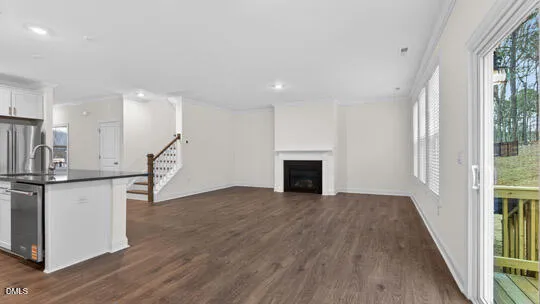 a view of a room with wooden floor and a balcony