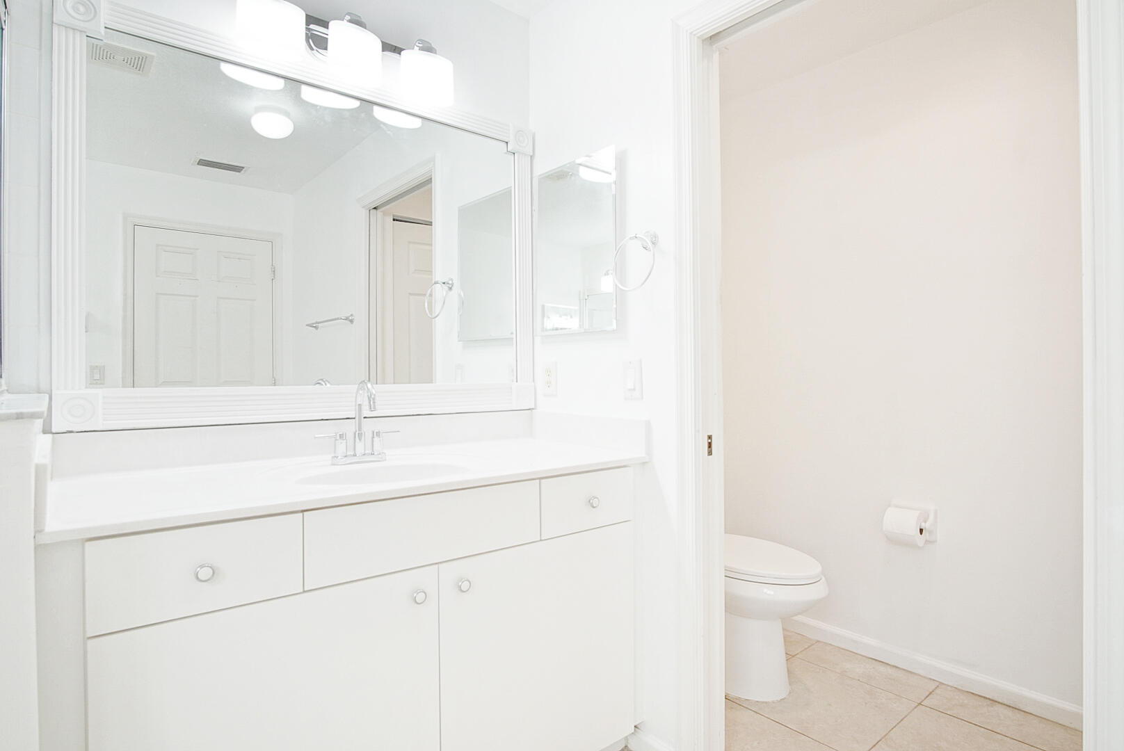 4483 Southeast Murray Cove Circle Stuart, FL 34997 - Photo 14 of 21 a bathroom with a toilet sink and a mirror