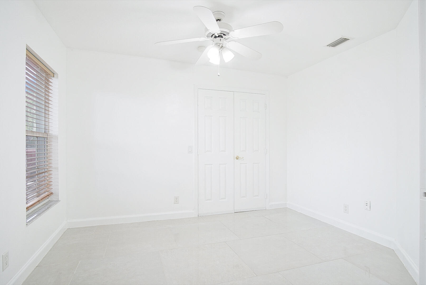 4483 Southeast Murray Cove Circle Stuart, FL 34997 - Photo 16 of 21 an empty room with a window and a ceiling fan