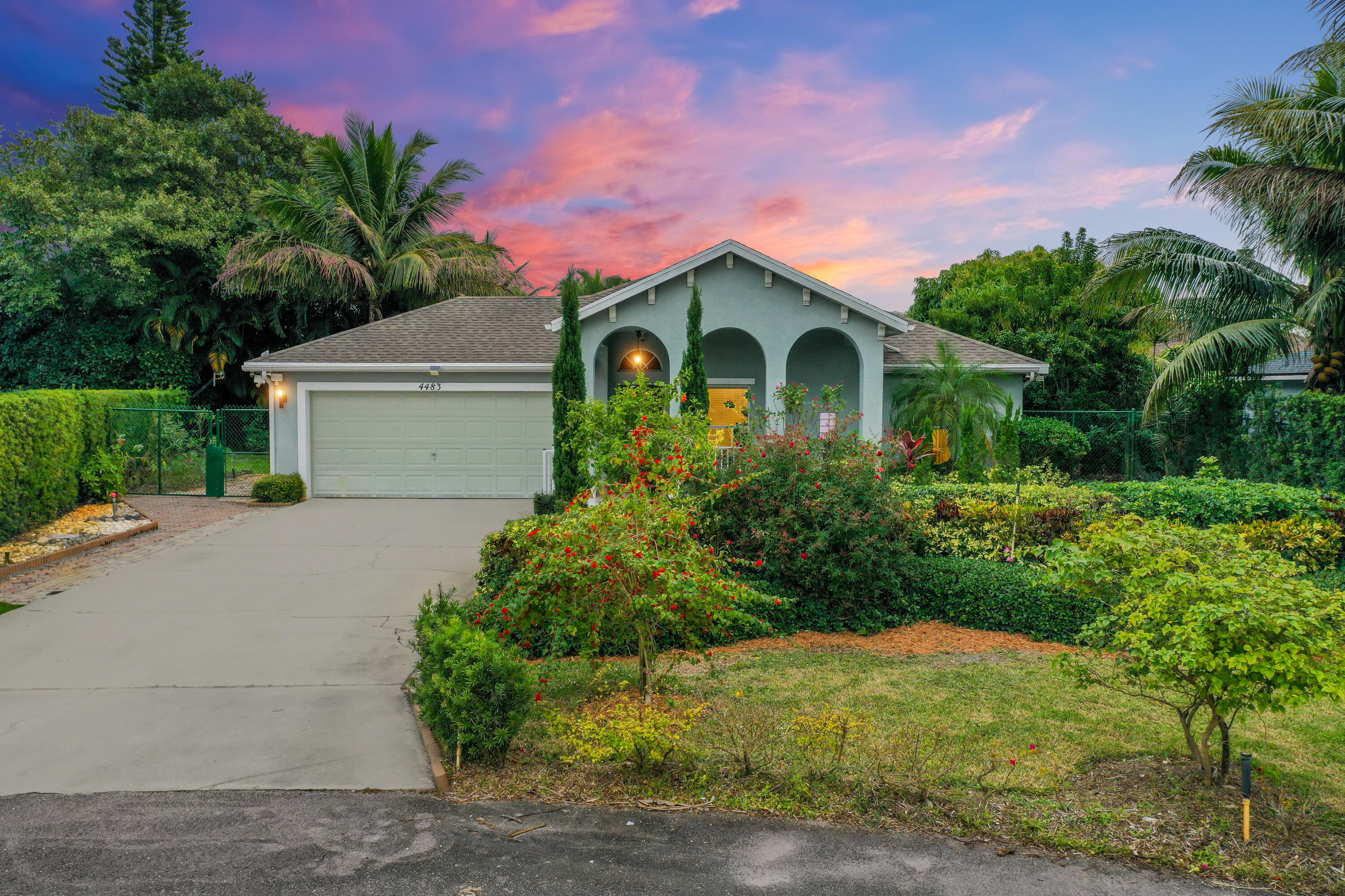 4483 Southeast Murray Cove Circle Stuart, FL 34997 - Photo 2 of 21 a front view of a house with garden