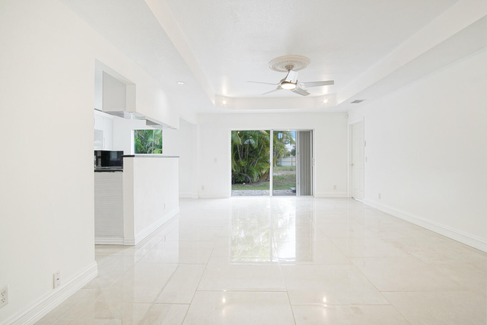 4483 Southeast Murray Cove Circle Stuart, FL 34997 - Photo 6 of 21 an empty room with windows and ceiling fan
