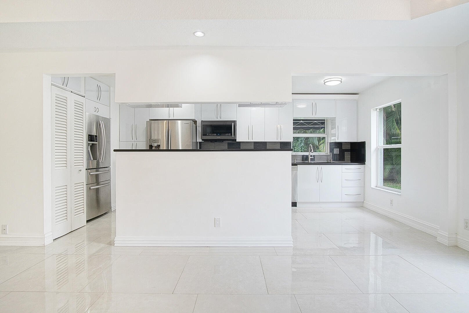 4483 Southeast Murray Cove Circle Stuart, FL 34997 - Photo 8 of 21 a kitchen with stainless steel appliances a refrigerator and a stove top oven