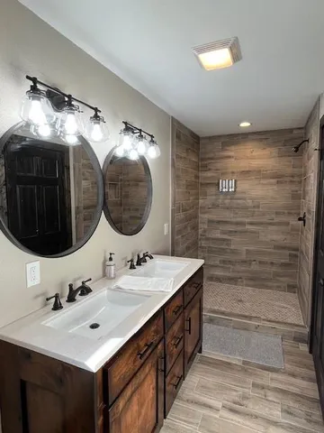 a bathroom with a double vanity sink and a mirror
