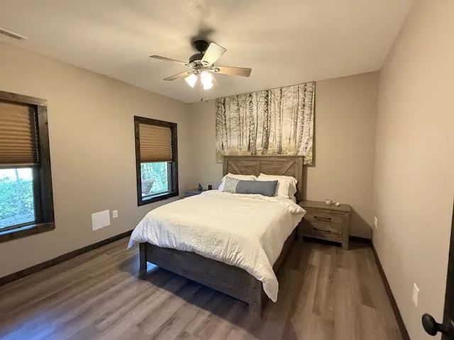a bedroom with a large bed chandelier and a window