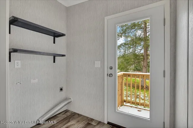 a view of small space with wooden floor and windows