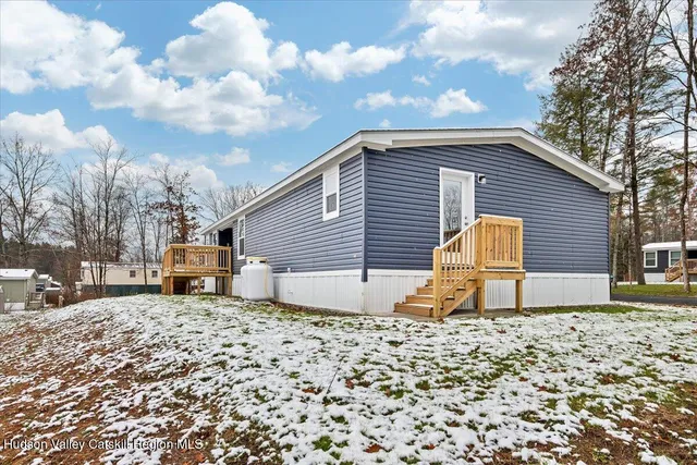 a backyard of a house with garage and barbeque oven