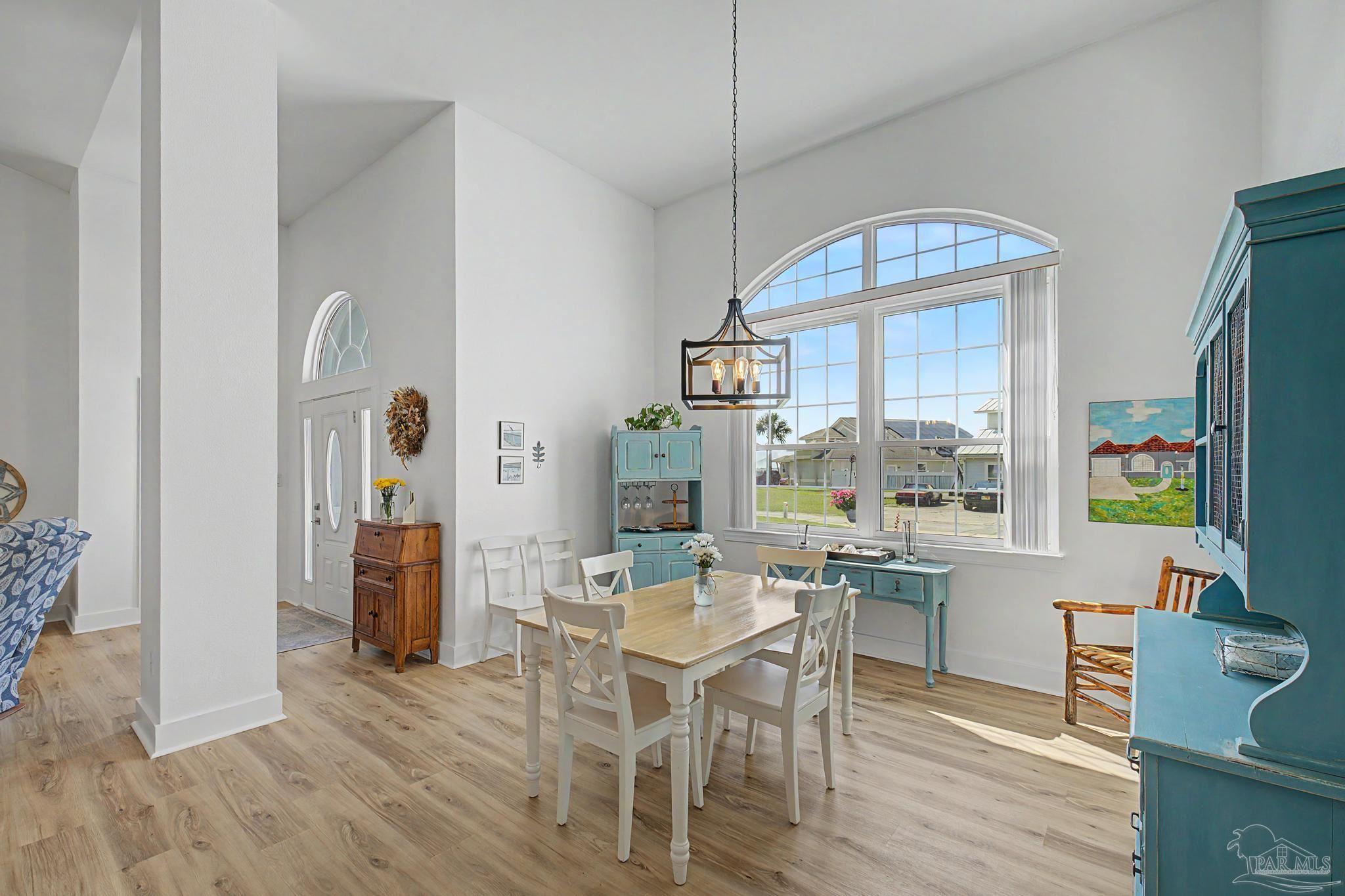 2005 Riviera Lane South Navarre, FL 32566 - Photo 7 of 70 a view of a dining room with furniture window and wooden floor