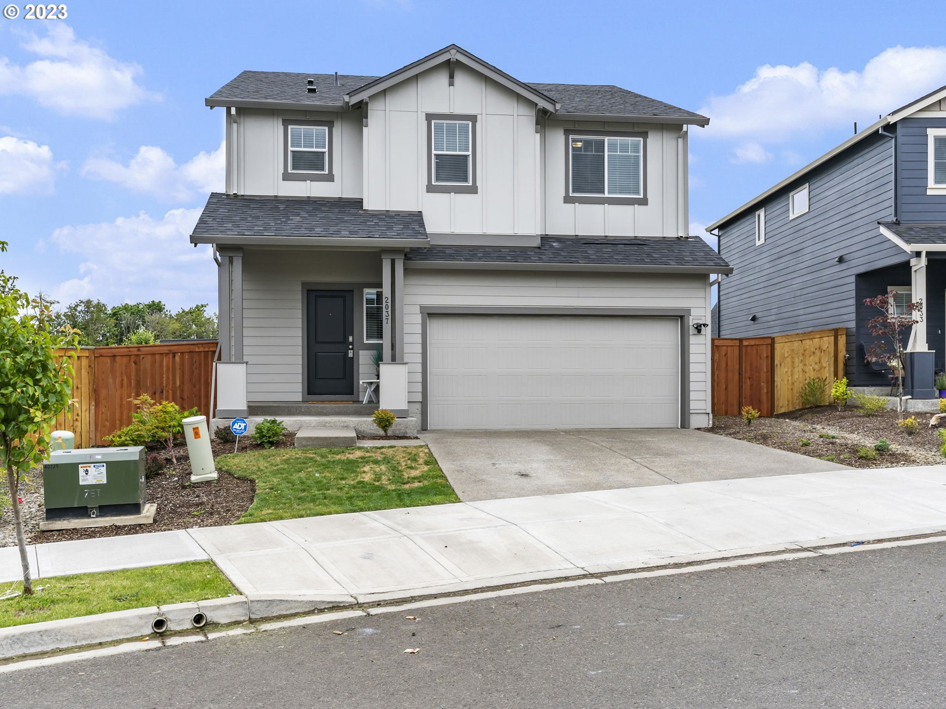 2037 South Meadowlark Dr. Loop Ridgefield, WA 98642 - Photo 1 of 39 a front view of a house with a yard and garage