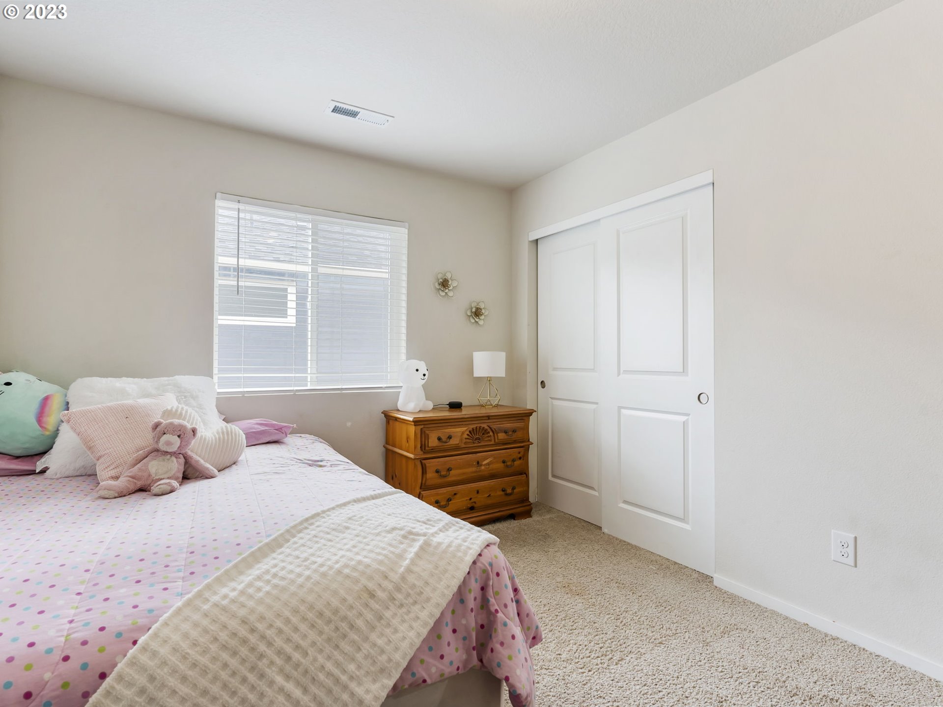 2037 South Meadowlark Dr. Loop Ridgefield, WA 98642 - Photo 25 of 39 a bedroom with a bed and wooden floor