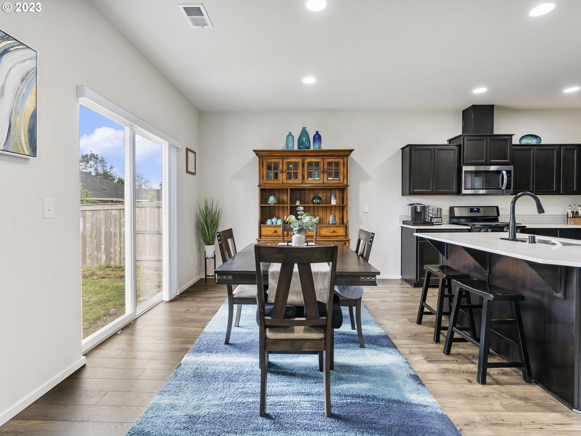 2037 South Meadowlark Dr. Loop Ridgefield, WA 98642 - Photo 10 of 39 a view of a dining room with furniture and wooden floor