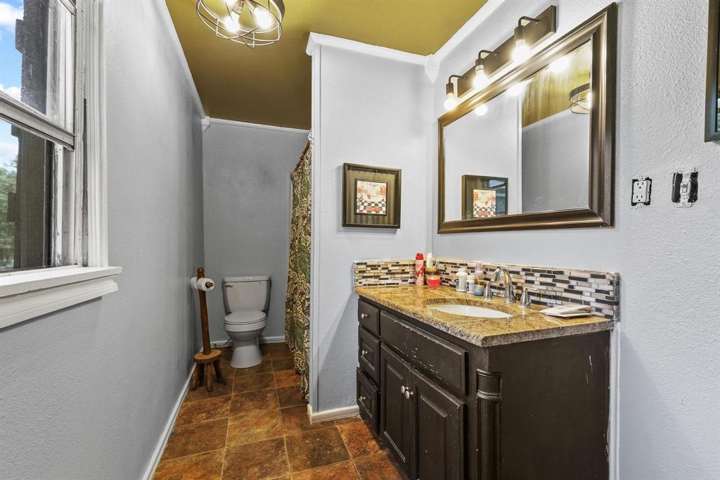 4453 Farm To Market 902 Howe, TX 75459 - Photo 35 of 40 Bathroom featuring a vanity with an undermount sink, granite-style countertop, and mosaic tile backsplash