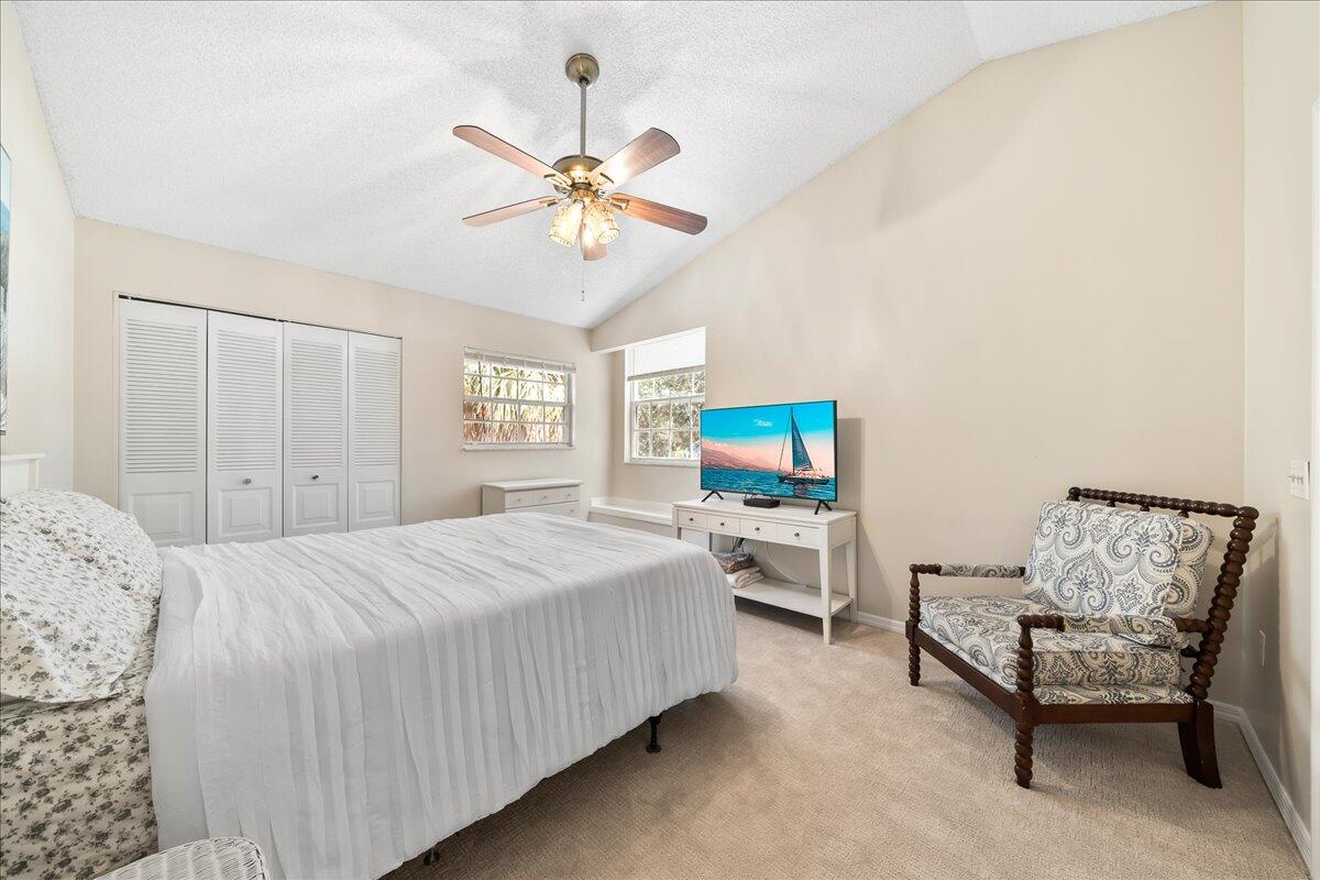 714 Players Court Melbourne, FL 32940 - Photo 11 of 23 a bedroom with a bed and a chandelier