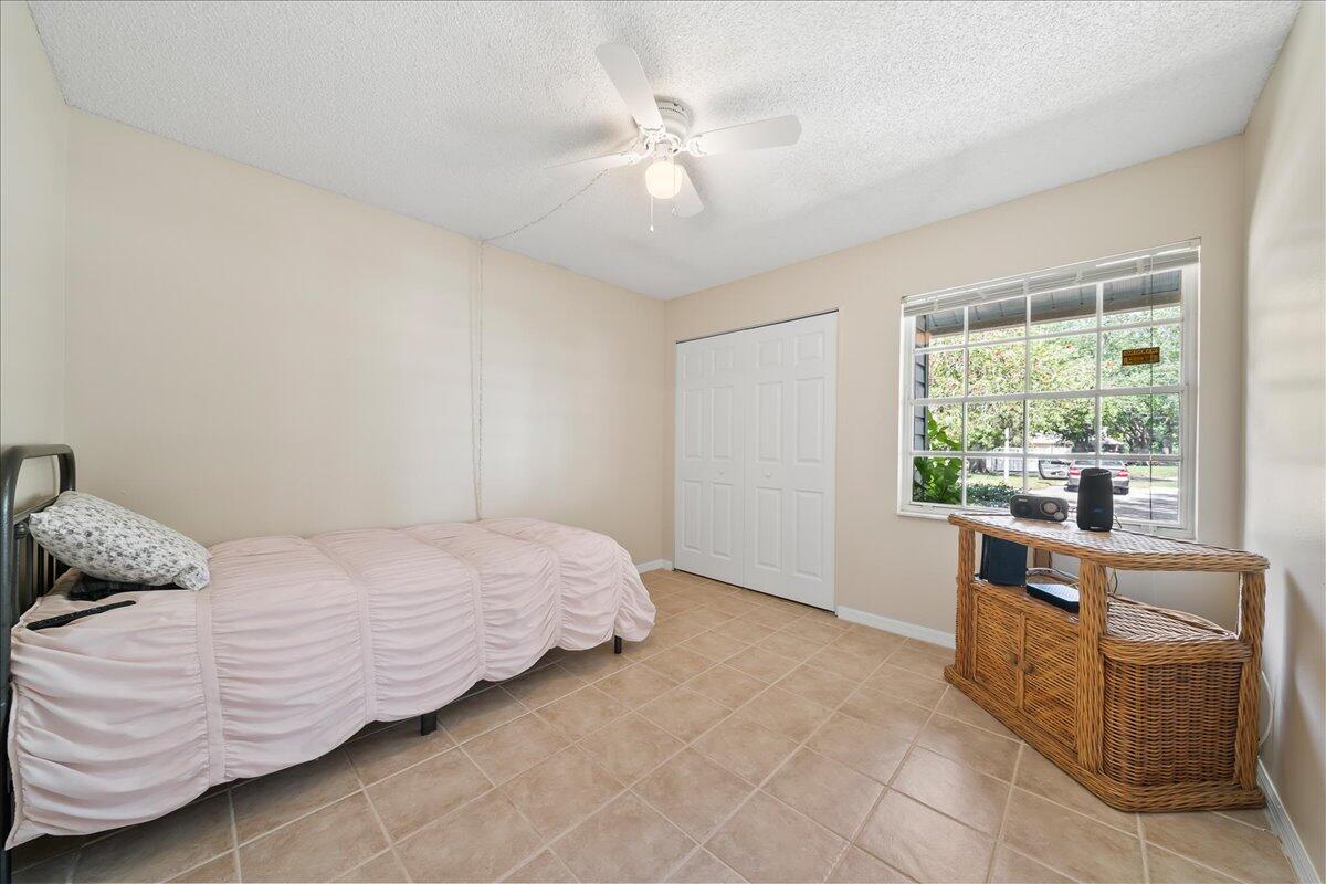 714 Players Court Melbourne, FL 32940 - Photo 13 of 23 a bedroom with a bed and window