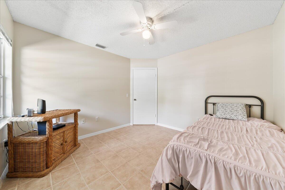 714 Players Court Melbourne, FL 32940 - Photo 14 of 23 a bedroom with a bed and furniture