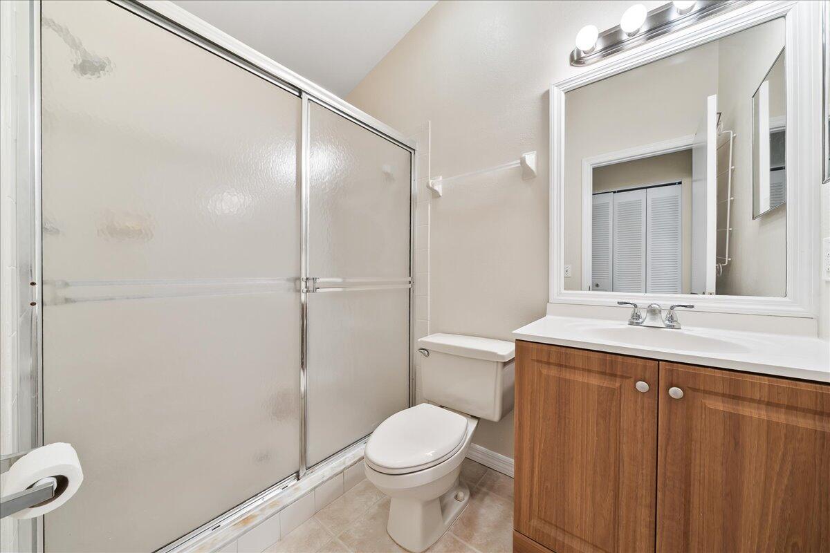 714 Players Court Melbourne, FL 32940 - Photo 17 of 23 a bathroom with a granite countertop sink toilet and shower