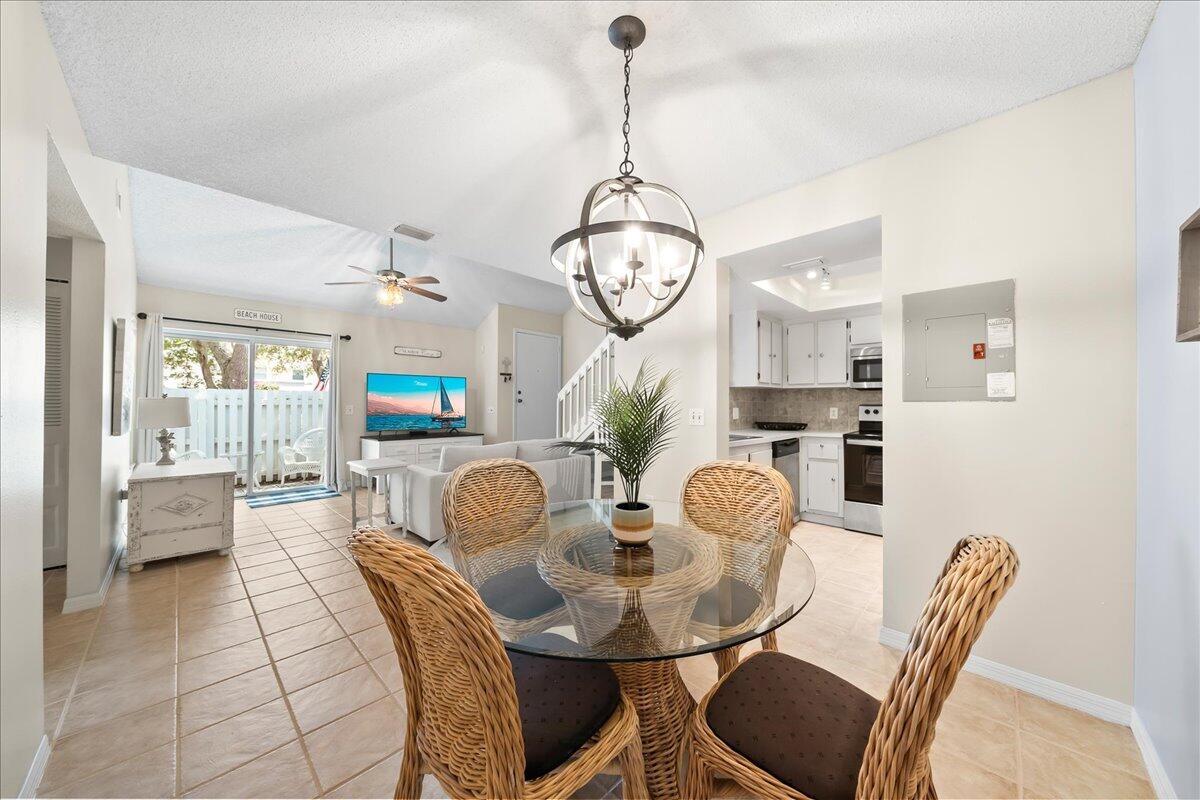 714 Players Court Melbourne, FL 32940 - Photo 6 of 23 a dining room filled chandelier and wooden floor