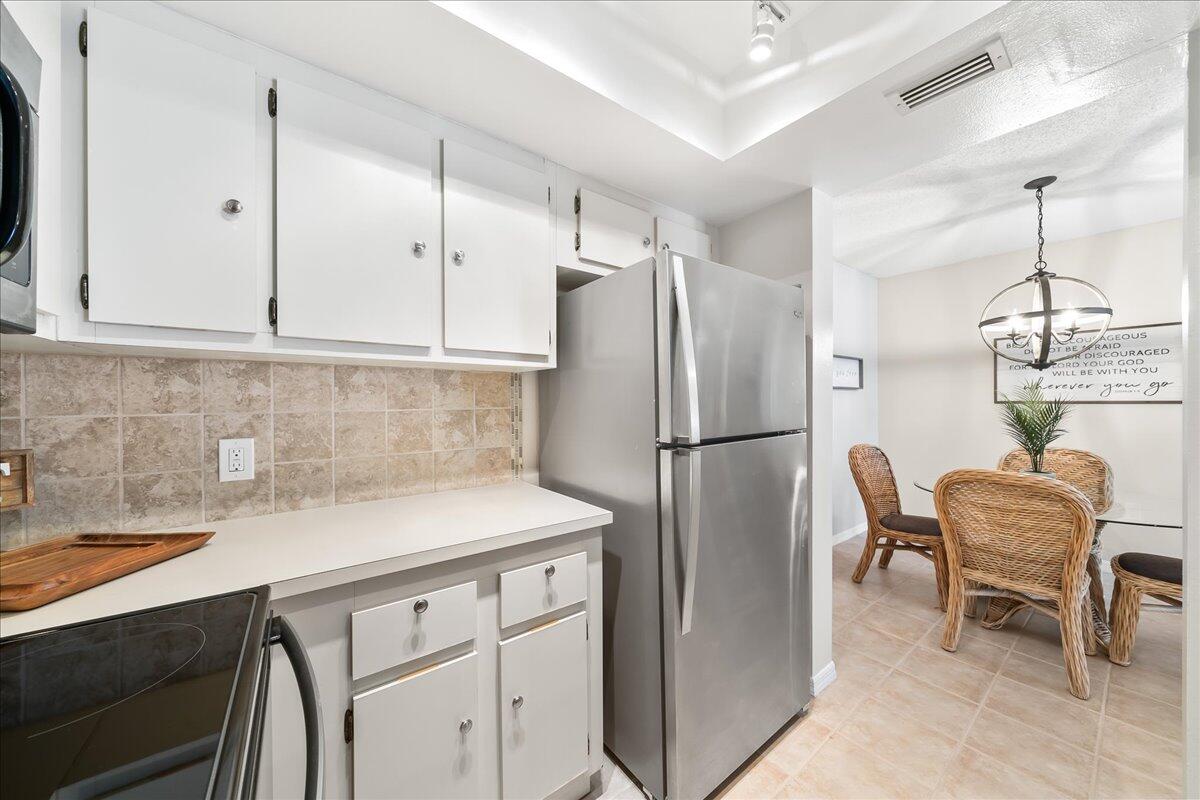 714 Players Court Melbourne, FL 32940 - Photo 9 of 23 a kitchen with stainless steel appliances granite countertop a refrigerator and a sink