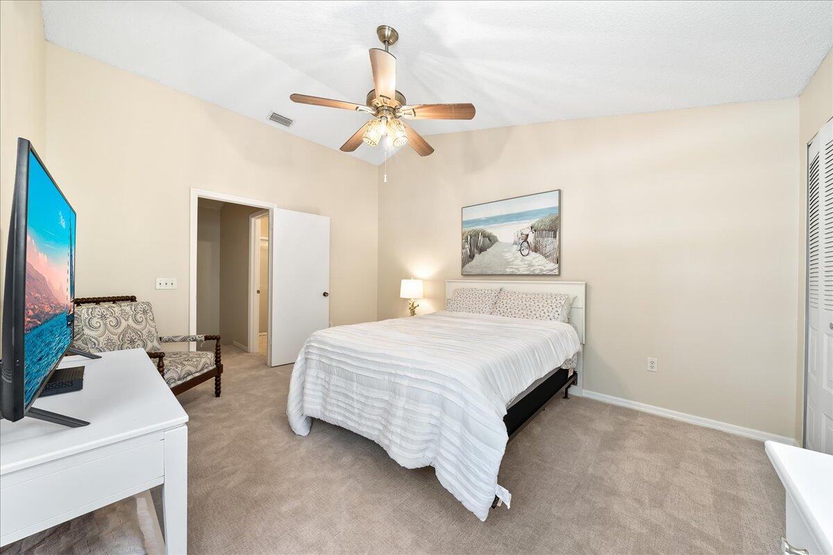 714 Players Court Melbourne, FL 32940 - Photo 10 of 23 a bedroom with a bed and a chandelier