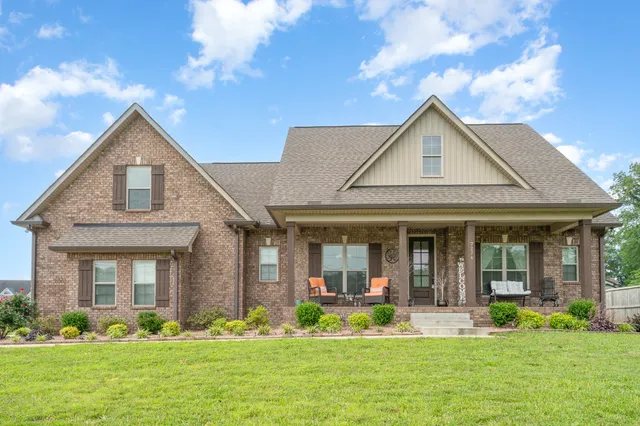 a front view of a house with garden