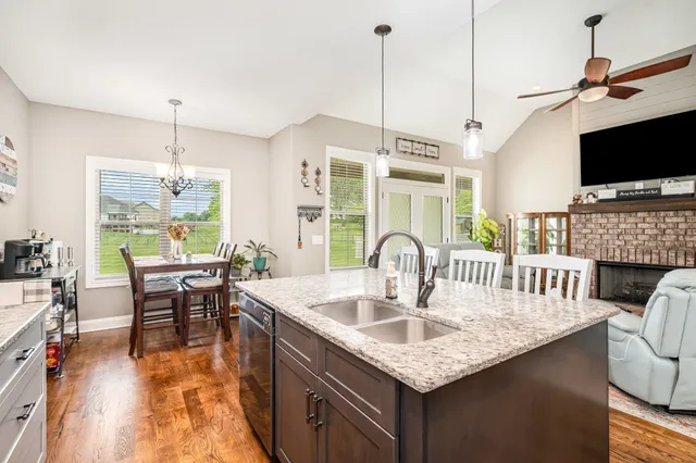 a kitchen with a table chairs and flat screen tv