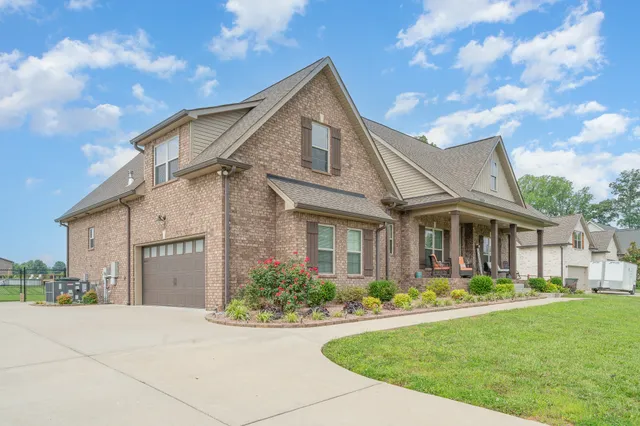 a front view of a house with a yard and garage