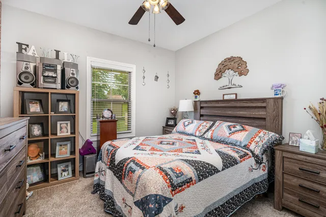 a bedroom with a bed and a chandelier