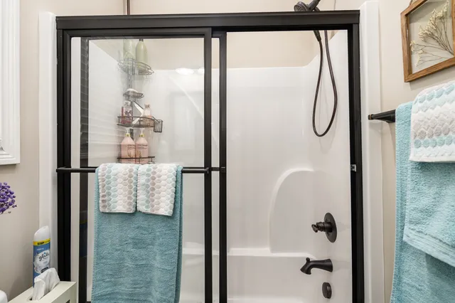 a bathroom with a glass shower door