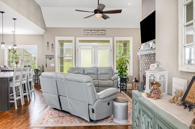 a living room with furniture and a flat screen tv