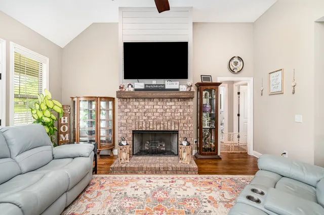 a living room with furniture fireplace and flat screen tv