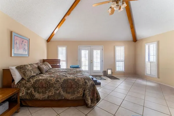 a living room with a bed furniture and next to a window
