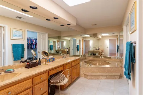 a large white kitchen with a large window