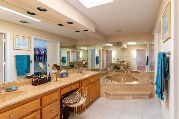 a large white kitchen with a large window