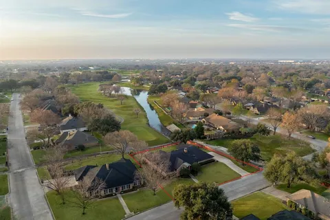 an aerial view of residential house with outdoor space and trees
