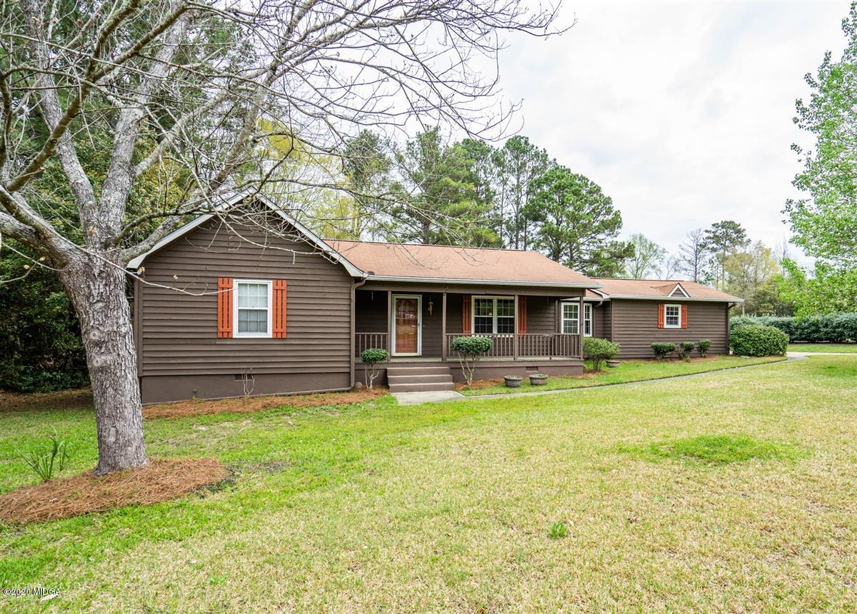 6345 Stapleton Road Macon, GA 31206 - Photo 1 of 21 a front view of a house with a garden and trees