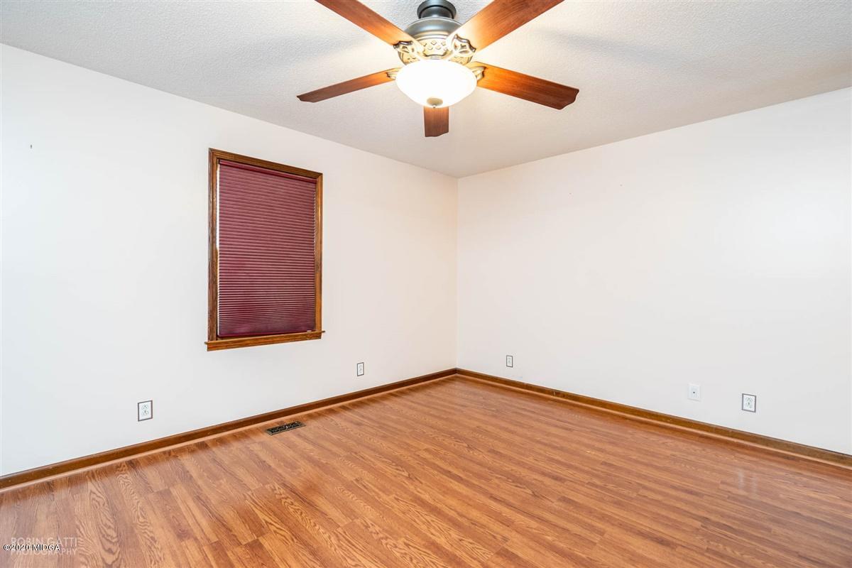 6345 Stapleton Road Macon, GA 31206 - Photo 13 of 21 an empty room with a ceiling fan and window