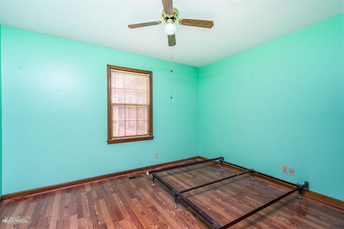 6345 Stapleton Road Macon, GA 31206 - Photo 17 of 21 a view of a room with wooden floor chandelier fan and windows