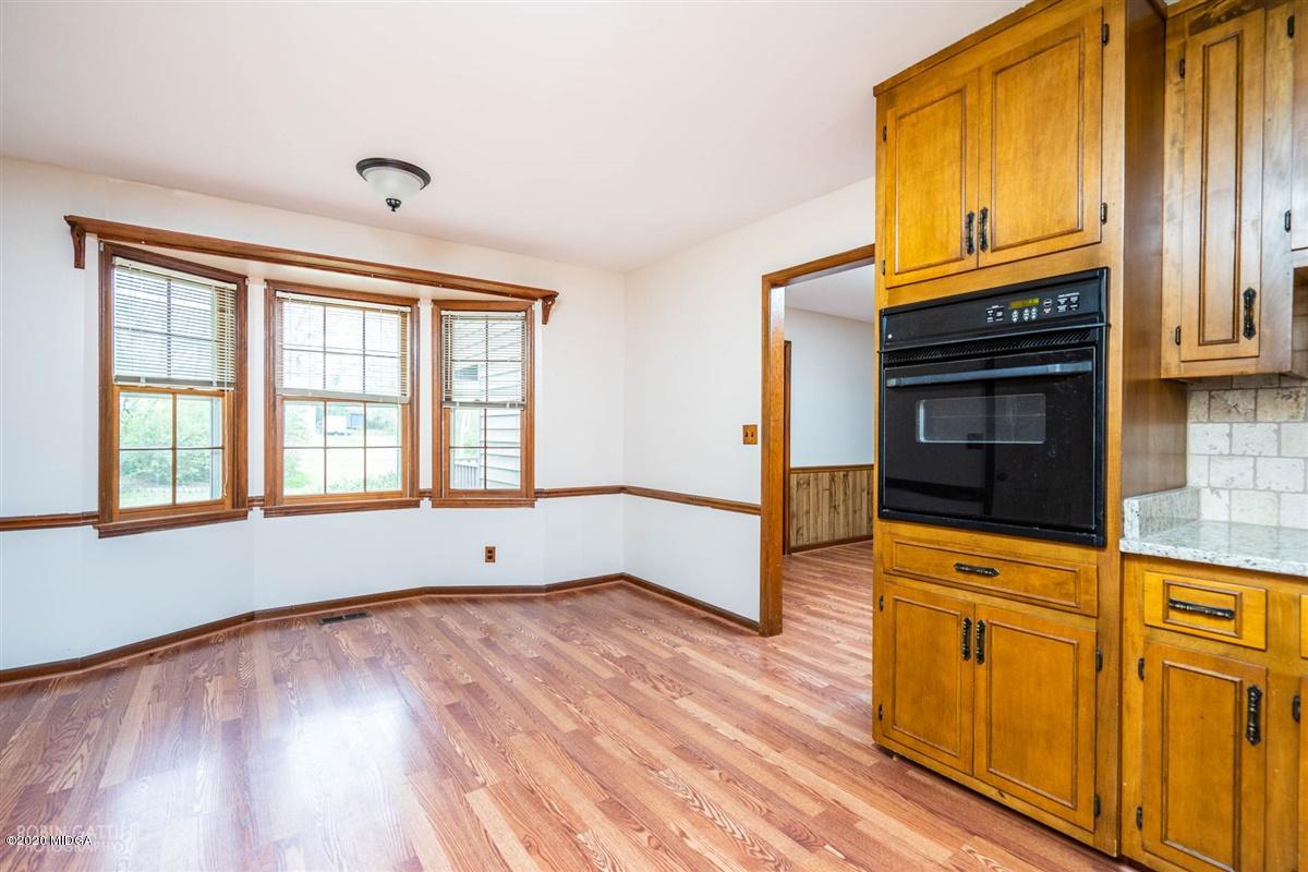 6345 Stapleton Road Macon, GA 31206 - Photo 7 of 21 a view of an empty room with wooden floor and a window