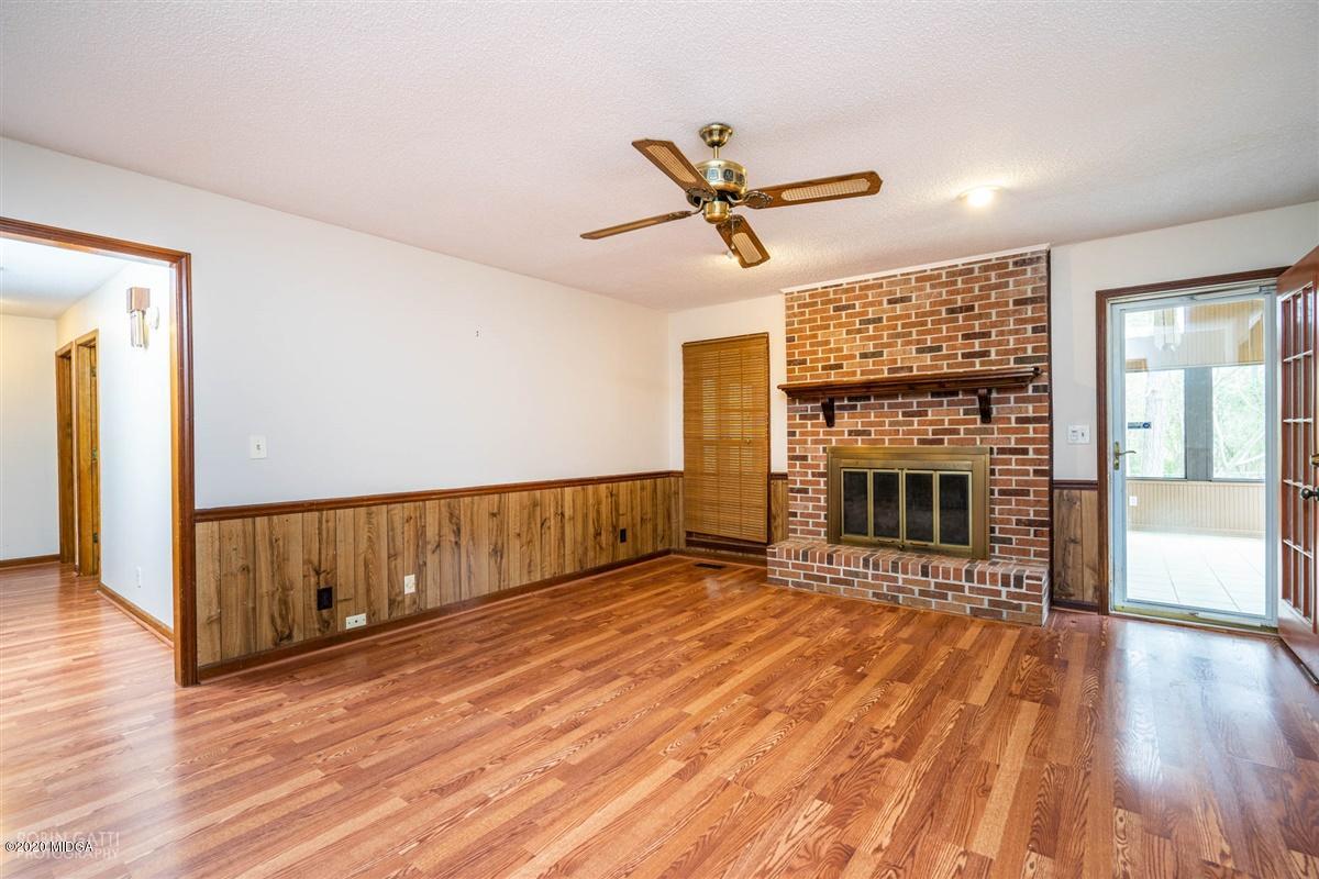 6345 Stapleton Road Macon, GA 31206 - Photo 9 of 21 a view of livingroom with fireplace wooden floor and window