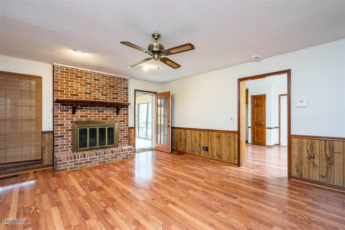6345 Stapleton Road Macon, GA 31206 - Photo 10 of 21 a view of a livingroom with wooden floor and a ceiling fan