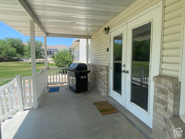 190 600 North Ferron, UT 84523 - Photo 60 of 85 Covered porch featuring a gas grill and double doors from the family room