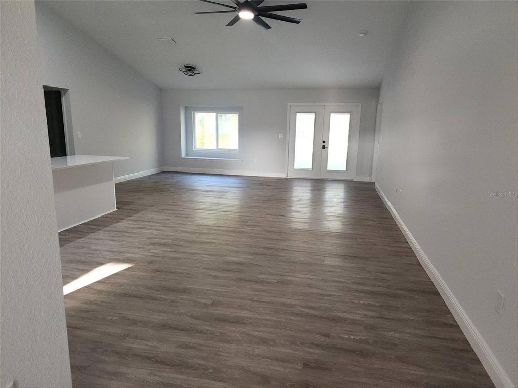 1111 Dagmar Avenue Spring Hill, FL 34606 - Photo 6 of 27 wooden floor in an empty room with a window