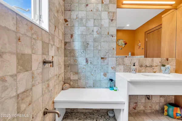 a bathroom with a sink a toilet and shower