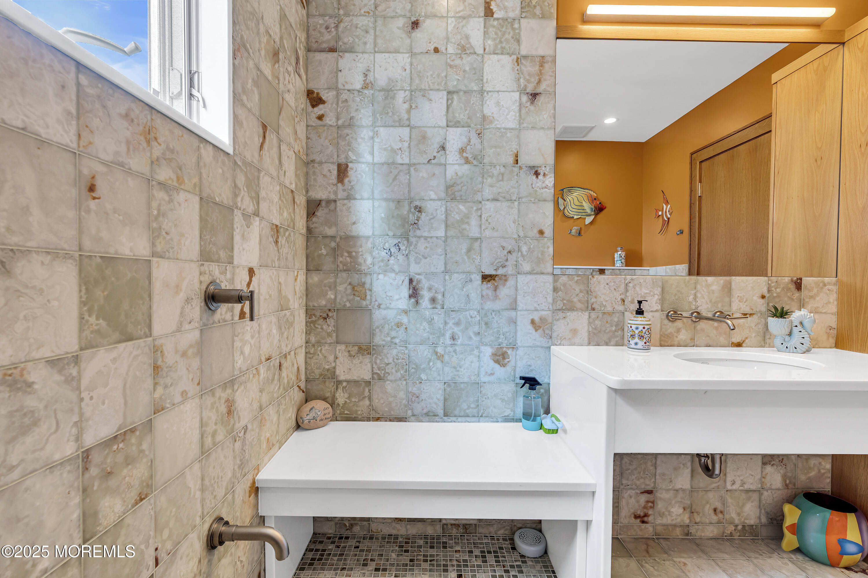 a bathroom with a sink a toilet and shower