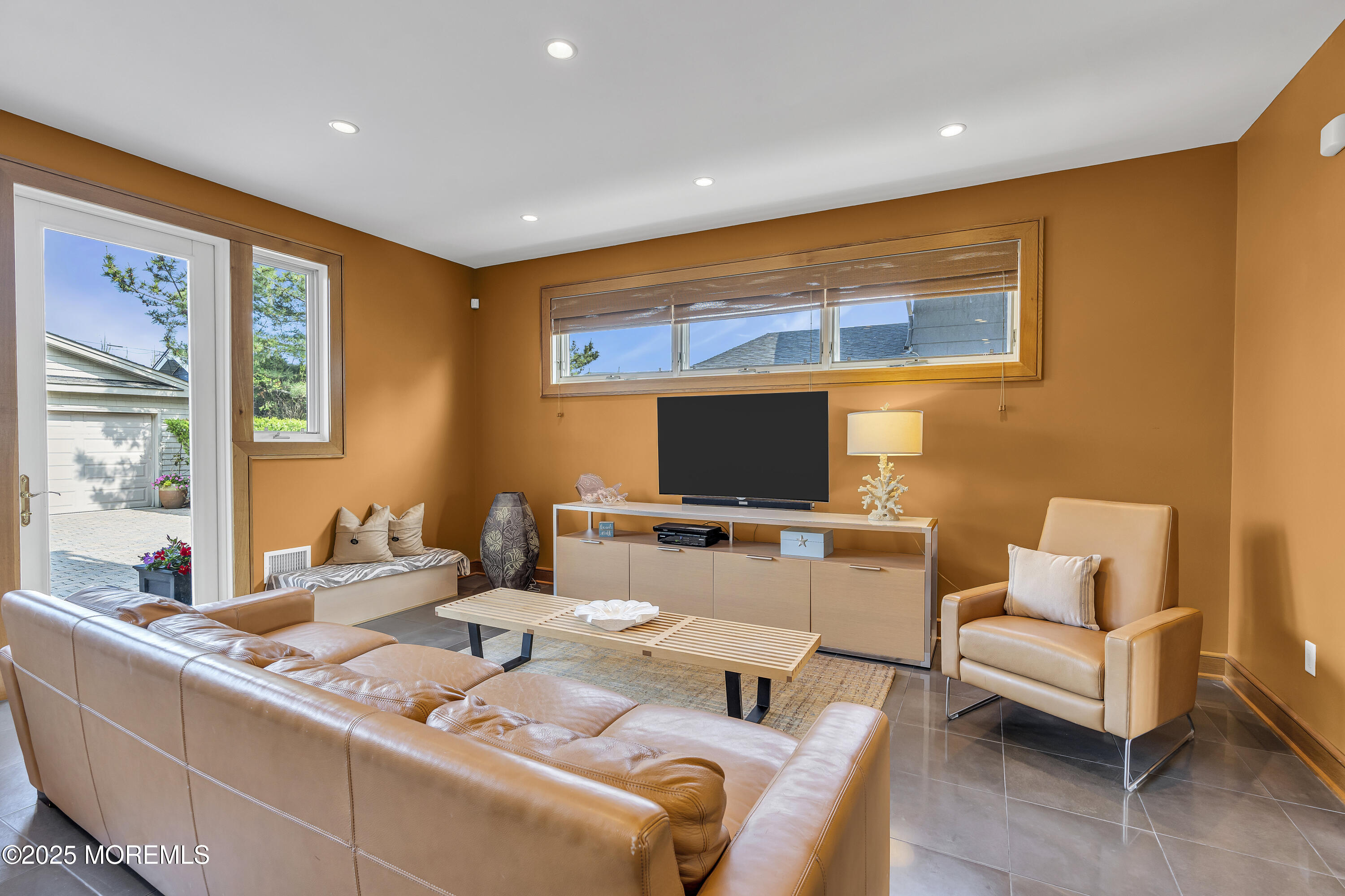 2009 North Ocean Avenue Spring Lake, NJ 07762 - Photo 32 of 91 a living room with furniture and a flat screen tv