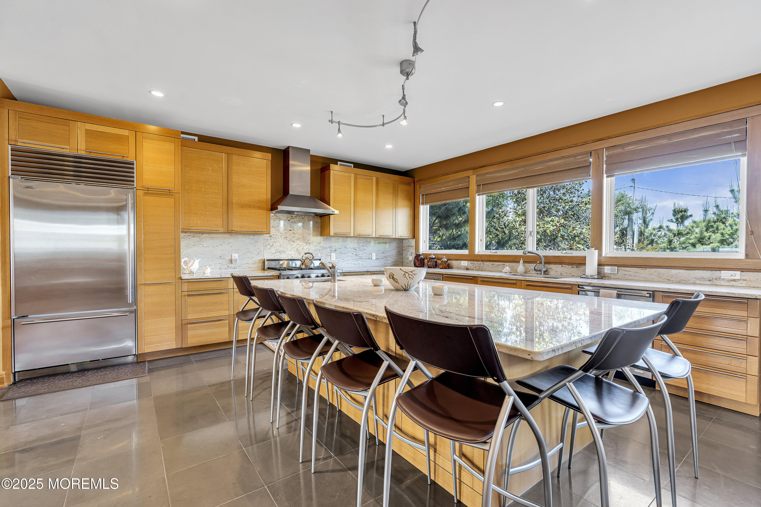 2009 North Ocean Avenue Spring Lake, NJ 07762 - Photo 35 of 91 a dining room with stainless steel appliances granite countertop a kitchen island a stove a refrigerator with a dining table and chairs with the wooden floor