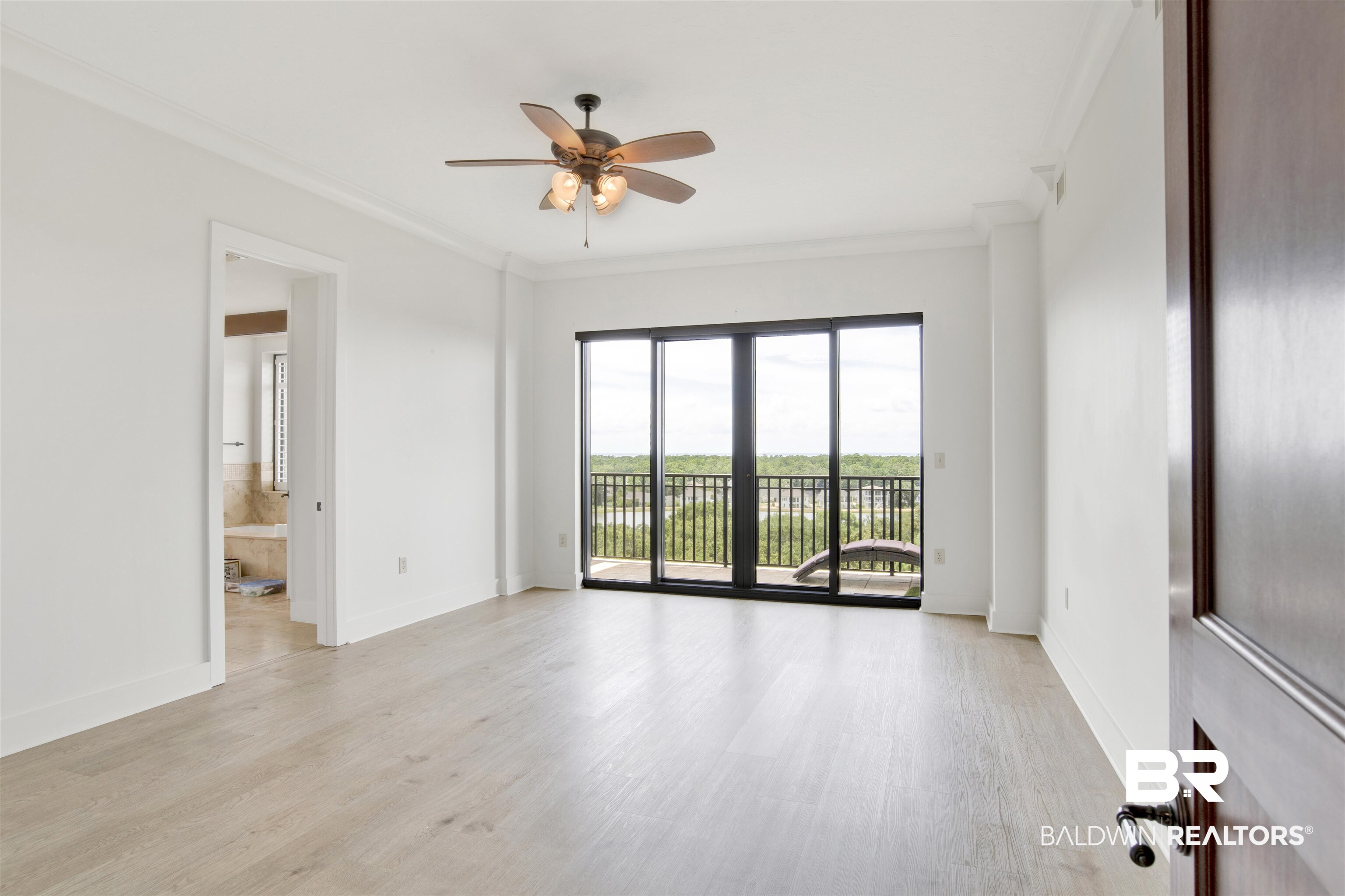 18269 Colony Drive, Unit 601 Fairhope, AL 36532 - Photo 5 of 47 Empty room featuring light wood-type flooring, ceiling fan, and ornamental molding