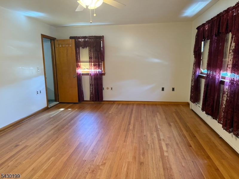 72 Baldwin Place, Unit 2 Bloomfield, NJ 07003 - Photo 20 of 24 wooden floor in an empty room with a window